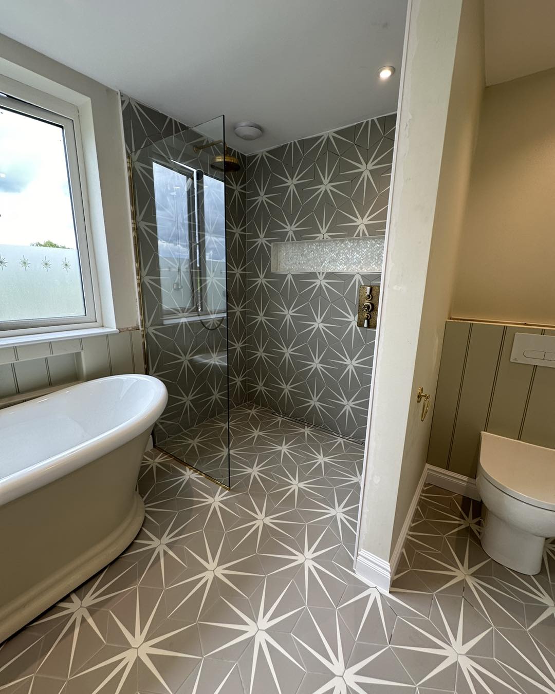 beige tiled wetroom shower area