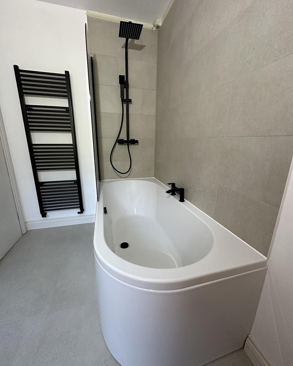 beige bath/shower with black hardware