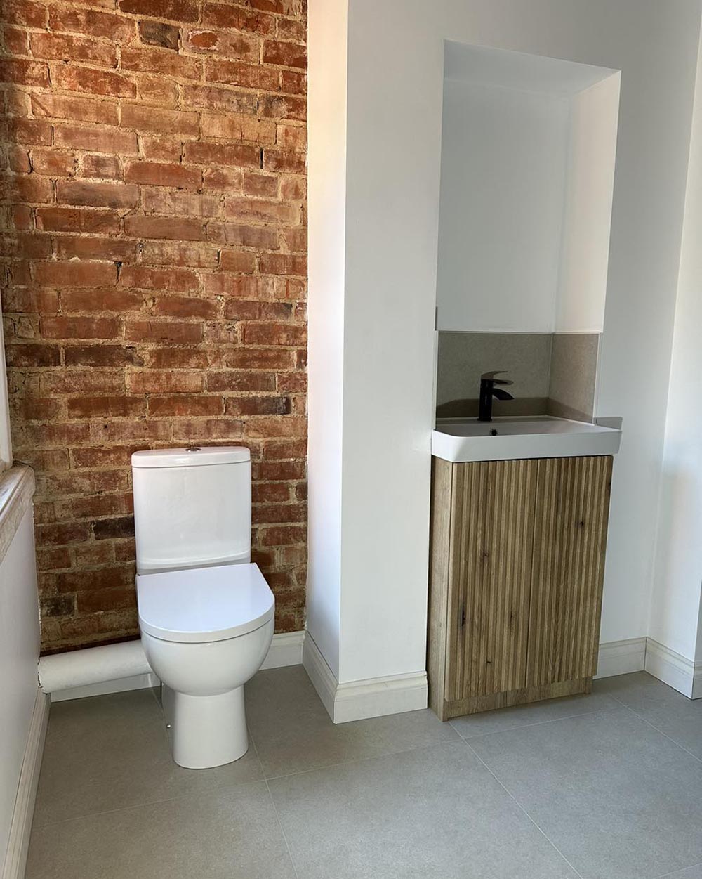 exposed brick wall for a rustic bathroom