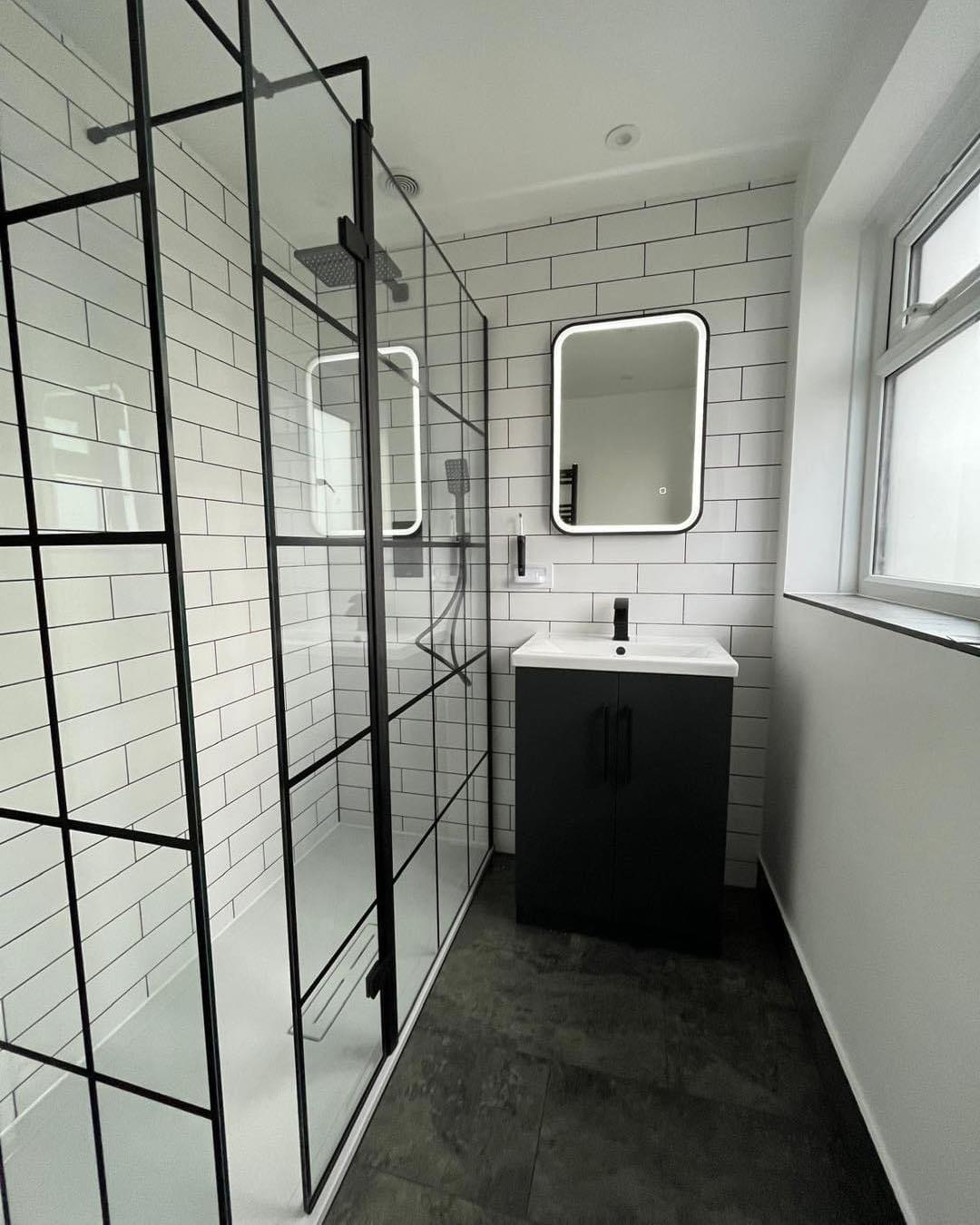 black and white bathroom with waterfall shower