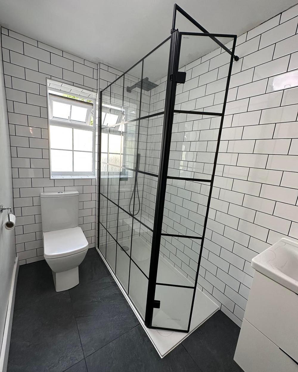 black and white bathroom with walk in shower